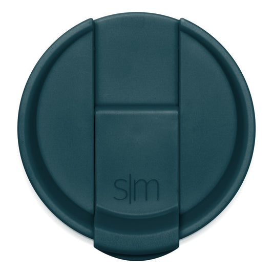 Teal-colored circular lid with raised rim, photographed from above against white background.