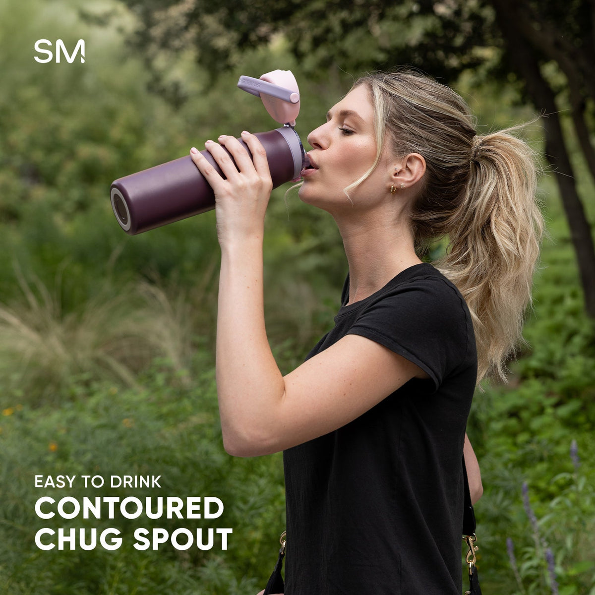 Mesa Sport water bottle with contoured chug spout, shown against a blurred green and earth-toned foliage background