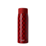 Deep red and burgundy bottle with geometric checkered pattern in alternating red tones and solid matte red cap
