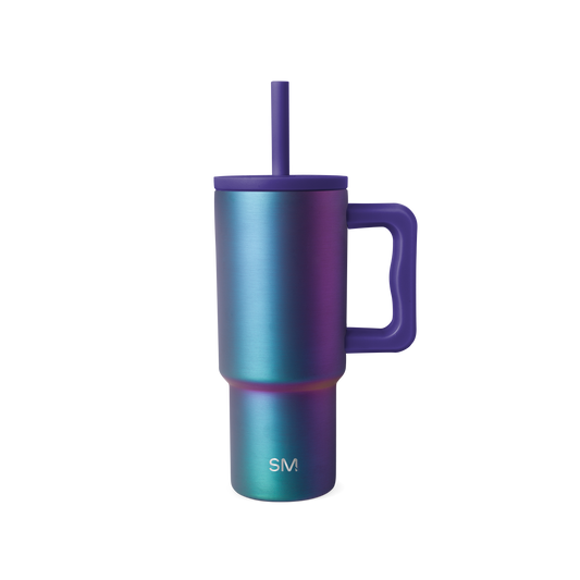 Stainless steel tumbler with handle and reusable straw, iridescent color-shift finish transitioning from turquoise to purple and blue.