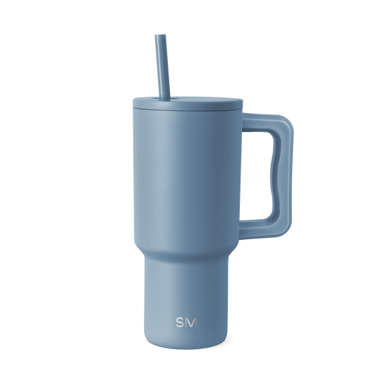 Soft blue-gray ceramic tumbler on white background, featuring a muted slate tone with cool undertones. Product shot for e-commerce display.