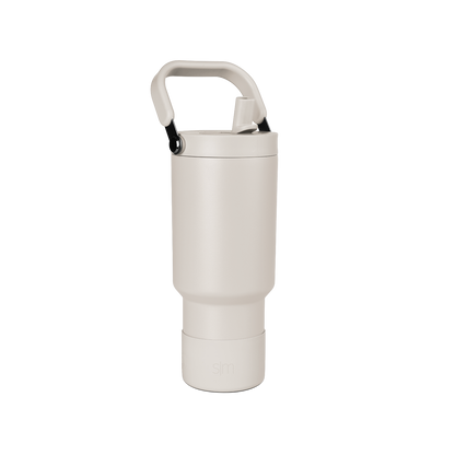 Pale beige cylindrical vessel with cream-colored closure cap on neutral off-white background.