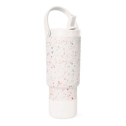 Cream-colored water bottle with multicolored speckled pattern including coral red, pink, teal, sage green, and muted orange accents.